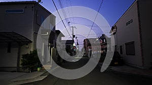 Walking in quiet Japanese neighborhood in predawn blue hour