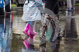 Walking through the rain in wellington boots. Legs only