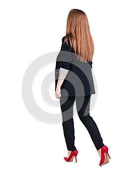 Walking red head business woman.