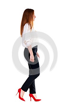 Walking redhead business woman.