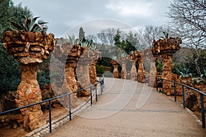 Walking road through columns at Guell park in Barcelona