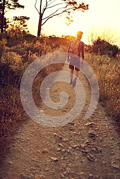 Walking on the road of life. a handsome young man enjoying a hike.