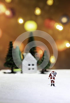 Walking Santa Claus on ice far from house and tree isolated from Christmas light background