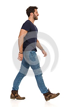Walking Smiling Man In Blue T-shirt, Jeans And Boots