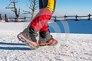 Walking on snow with Snow shoes and Shoe spikes in winter.