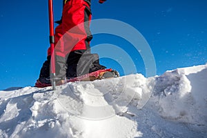 Walking on snow with Snow shoes and Shoe spikes in winter.