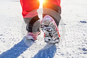 Walking on snow with Snow shoes and Shoe spikes in winter.