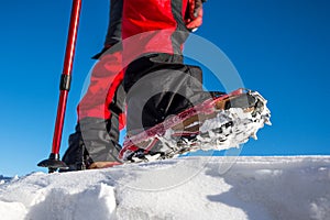 Walking on snow with Snow shoes and Shoe spikes in winter.