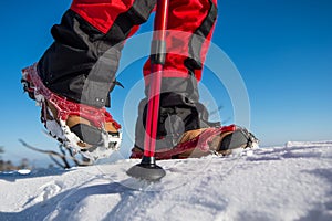 Walking on snow with Snow shoes and Shoe spikes in winter.