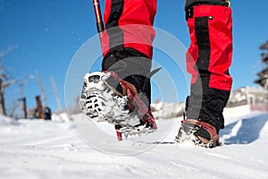 Walking on snow with Snow shoes and Shoe spikes in winter.