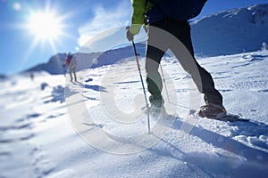 Walking in a snowshoes on a mountain snowy plateau