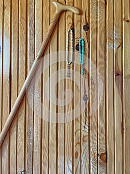 Walking sticks and rosaries hanging on the wooden wall