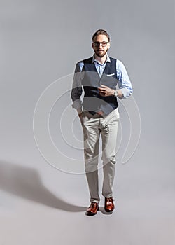 Walking suave stylish bearded man in classic vest