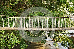 Walking suspense bridge made of dry bamboo in Tay Nguyen, central highlands of Vietnam, Asia