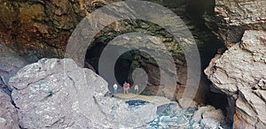 walking in to a cave on the north Cornwall coast