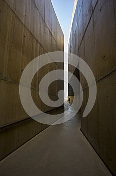 Walking to the light between big walls in Vila Nova de Foz Coa Museum.