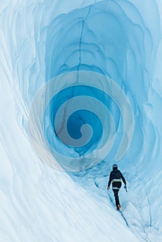 Walking toward an ice cave with deep blue ice  on the Matanuska Glacier in Alaska