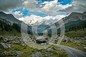 Walking trail with large rocks and beautiful mountains in background