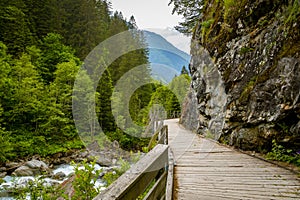 Walking trail near Charstelenbach stream in Maderanertal valley in Switzerland