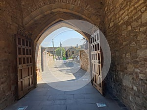 Walking under a arched castle entrance