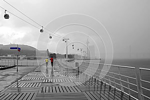 Walking way at Tagus riverside with cable car railway in Parque das Nacoes