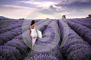 Walking women in the field of lavender.Romantic women in lavender fields. Girl admires the sunset in lavender fields.