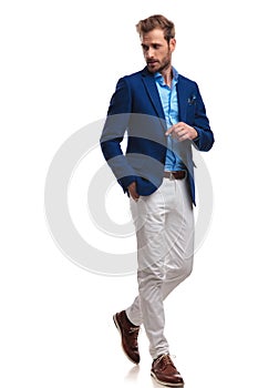 Walking young smart casual man looks back over his shoulder photo