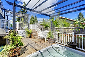 Walkout deck with jacuzzi and pergola