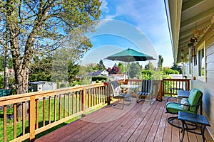 Walkout deck with patio table set and umbrella.