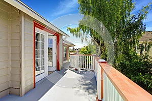 Walkout deck with white railings and orange trim