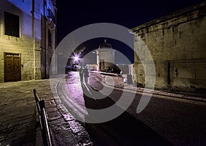 Walks in the dark streets of the Valletta. Towers of the old city. Malta.