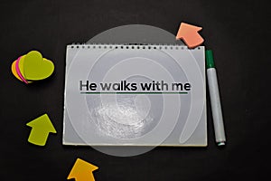 He Walks with Me write on a book  on office desk. Christian faith concept