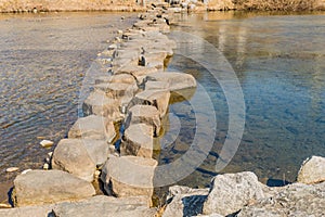 Walkway across river made of large boulders