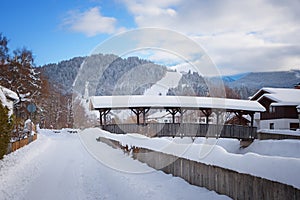 Walkway along loisach river garmisch with bridge and view to ski