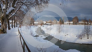 Walkway along loisach river in winter