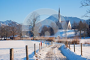walkway Bad Wiessee, view to church and bavarian alps, winter landscape bavaria