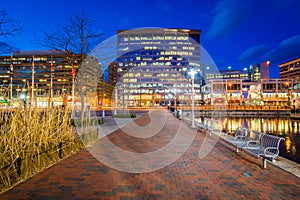 Walkway and buildings along Pratt Street at night, in the Inner Harbor, Baltimore, Maryland