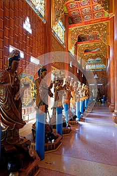 Walkway in Chinese Buddhist temple, Wat Metta Dharma Bodhiyan, with wooden statues of Bodhisattvas, Kanchanaburi