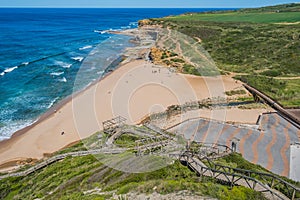 Walkway on a hill in aerial view in Ribeira D\'Ilhas beach, Ericeira - Mafra PORTUGAL photo