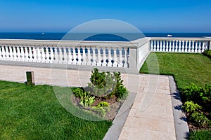 Walkway of marble tiles and stone balustrades.