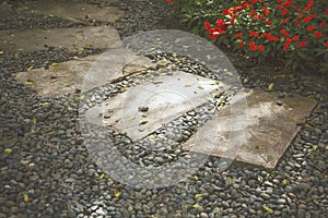 Walkway paved with stone slabs in flower garden