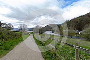 Walkway from Pooley Bridge village to the scenic lakeside of Ullswater in Lake District National Park, England, UK