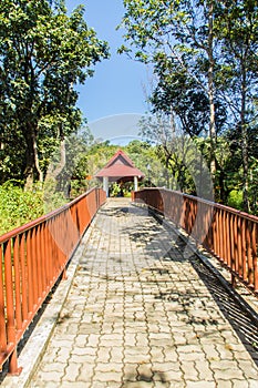 Walkway into the publuc temple in the forest that constructed with brick floor and steel fence