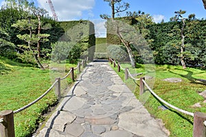 A walkway with roped boundary in a garden