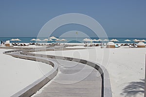 Walkway to idyllic beach with pure white sand