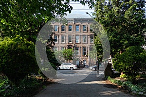 Walkway at Van Vorst Park with a Row of Old Brownstone Homes in Jersey City New Jersey