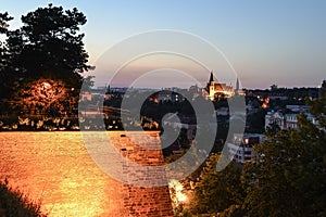 Walkway on Vysehrad fortification walls illuminated by street lamps by night. Prague, Czech Republic