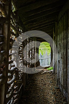Walkway Through Wooden Fort With Palisade Fencing In Background