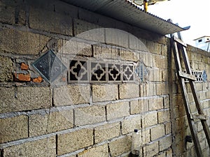 the wall and the air vent behind the neighbor's house