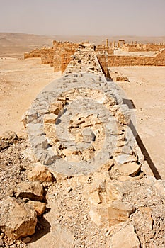 Wall of the ancient fortress in the desert during